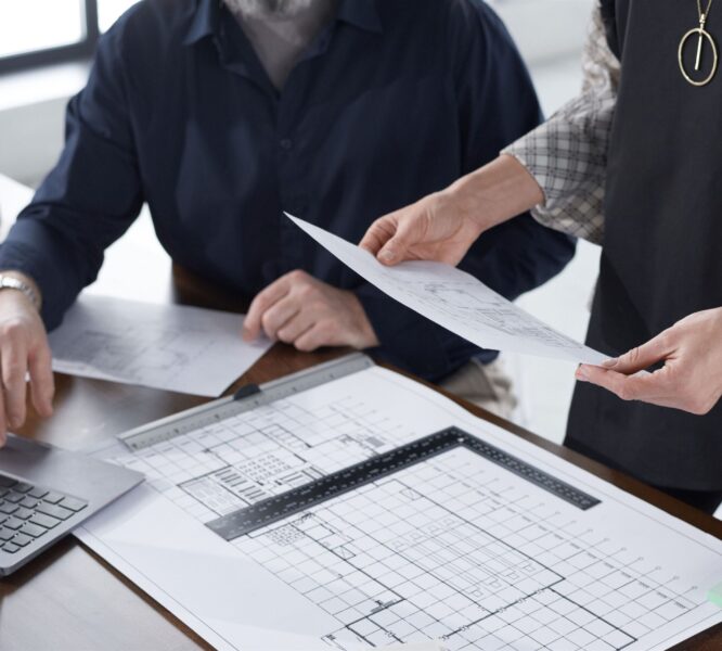 Close-up of architects examining blueprints together and developing new project at office Mass Image Compressor Compressed this image. https://sourceforge.net/projects/icompress/ with Quality:80